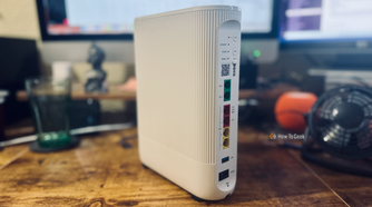 A Vodafone Ultra Hub 7 router on a desk in front of a computer.