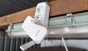 A Wi-Fi Extender plugged into an extension cable.