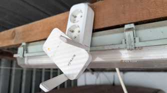 A Wi-Fi Extender plugged into an extension cable.