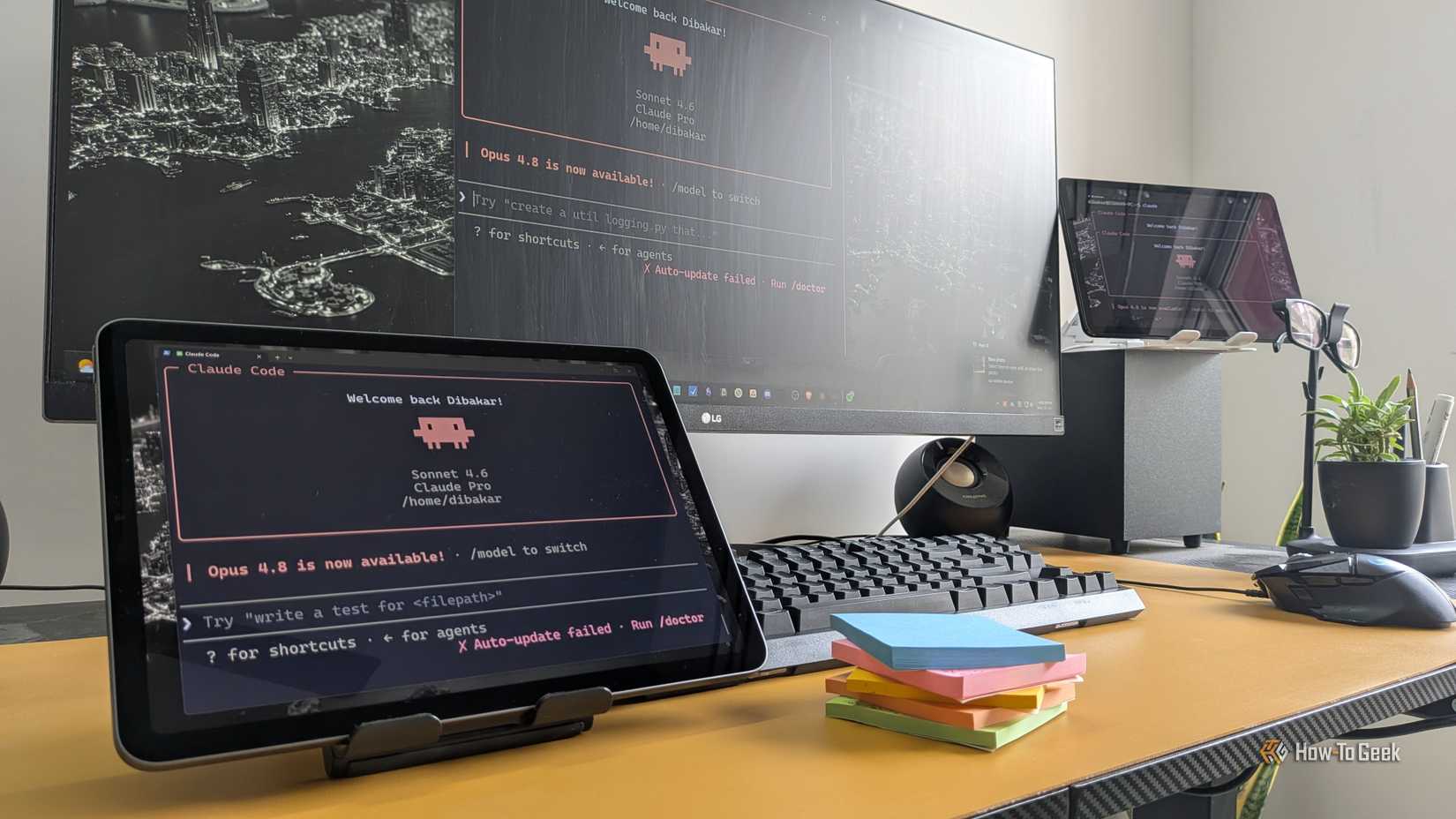 Claude Code open on a tablet and monitor on a desktop.