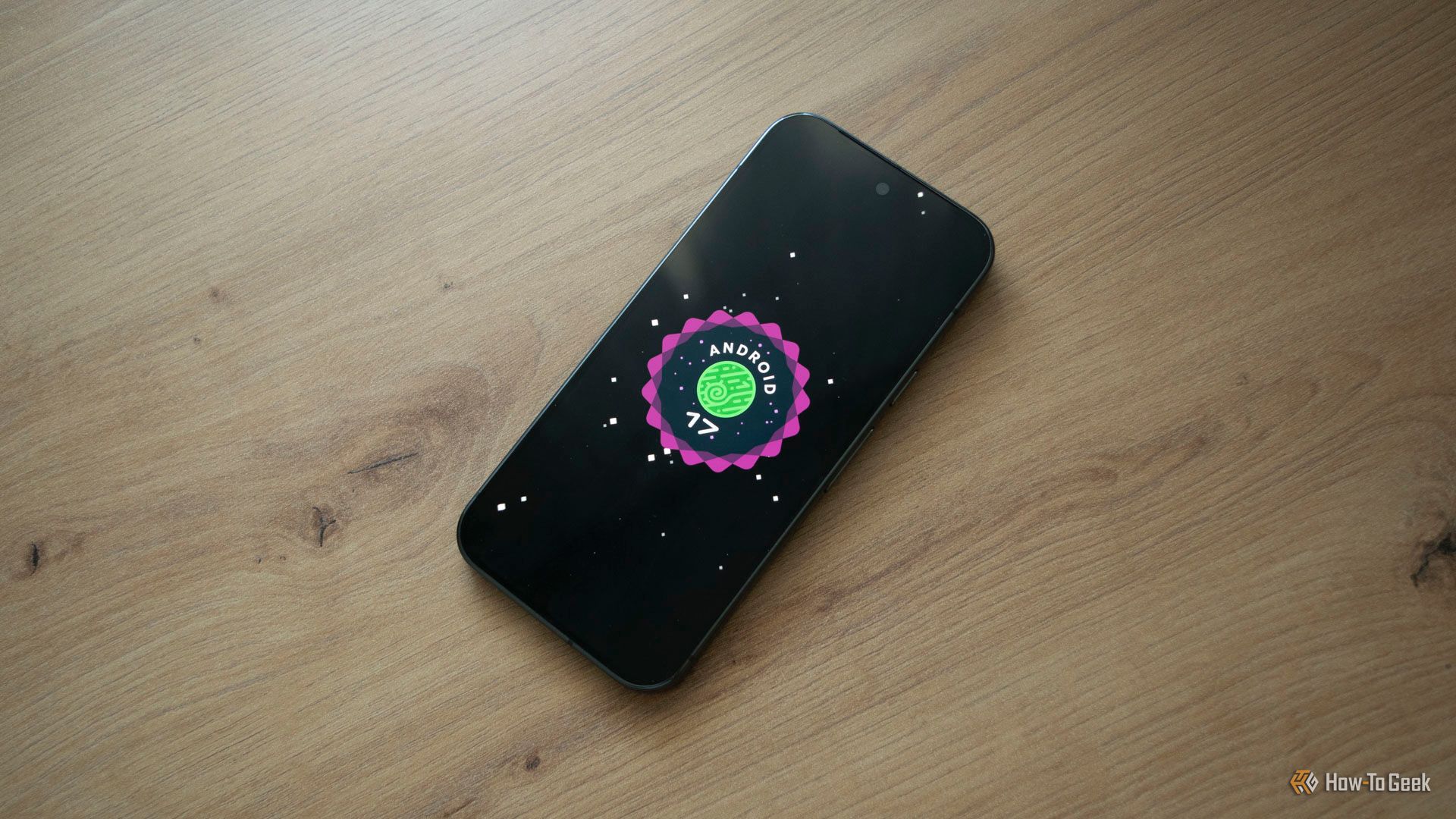 A Pixel 10 Pro lying on a table, showing Android 17 Logo. 