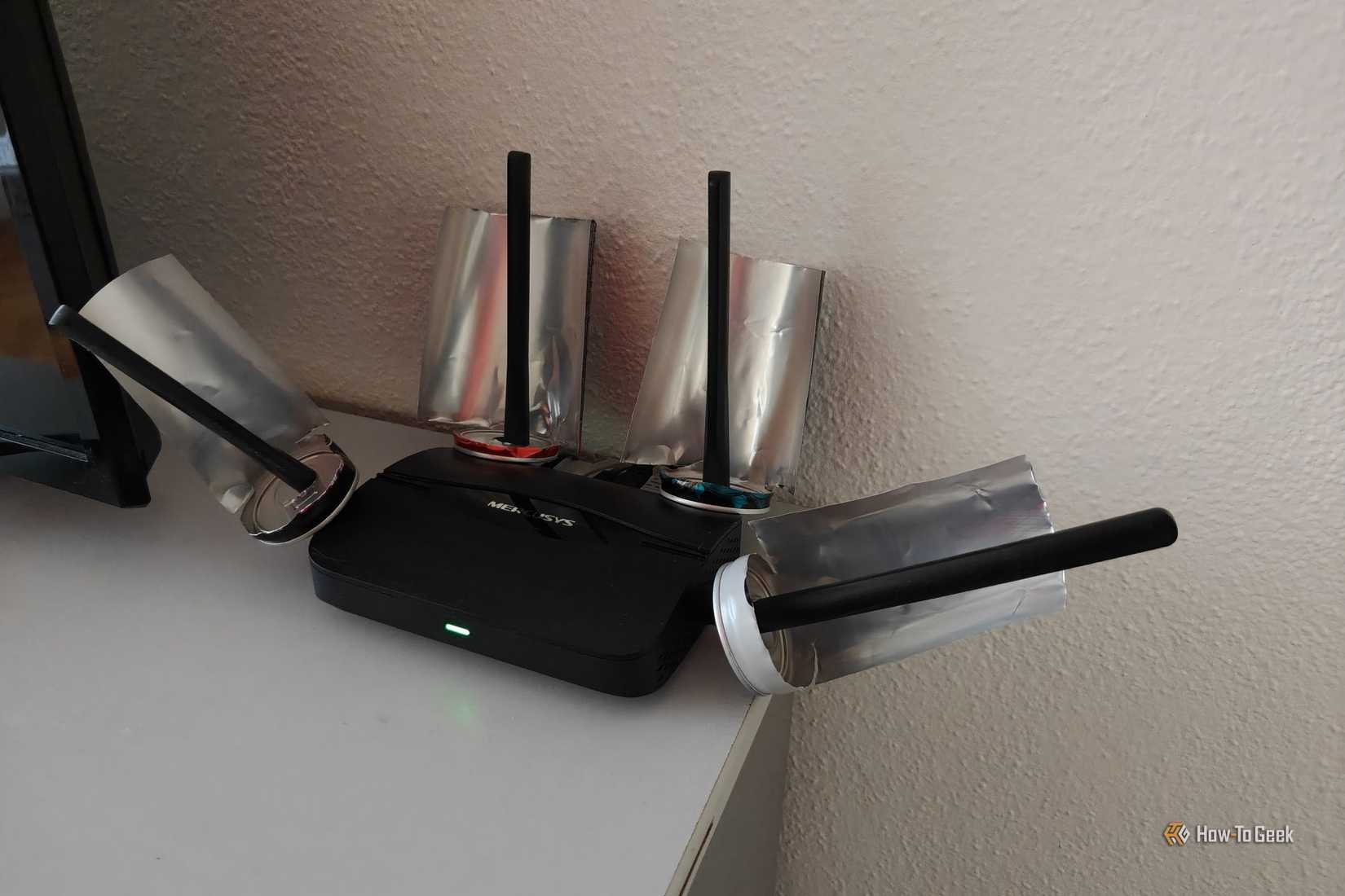 A Wi-Fi 7 router with some soda cans on each antenna.