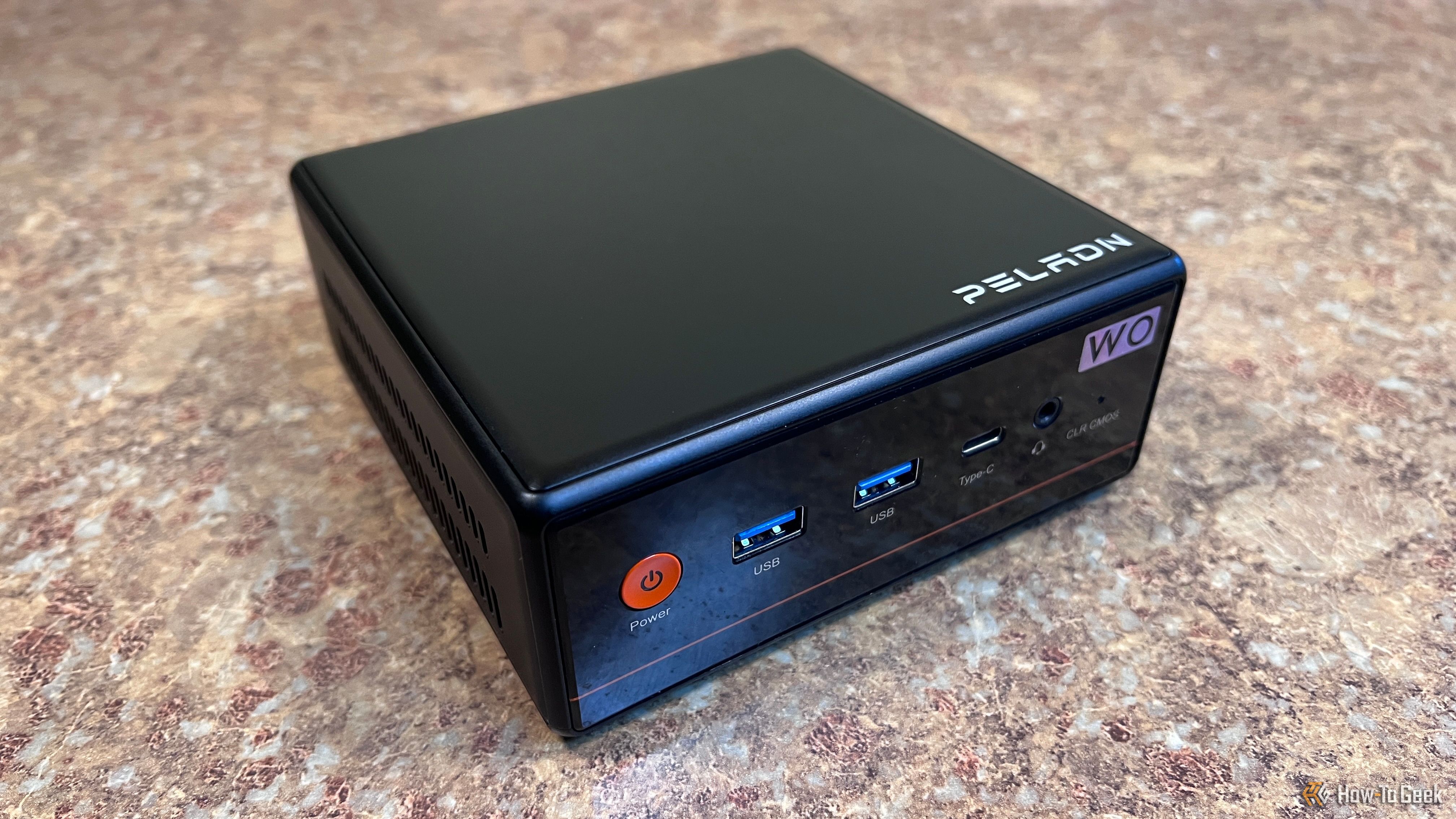 An image of a Peladn W04 mini PC sitting on a countertop.