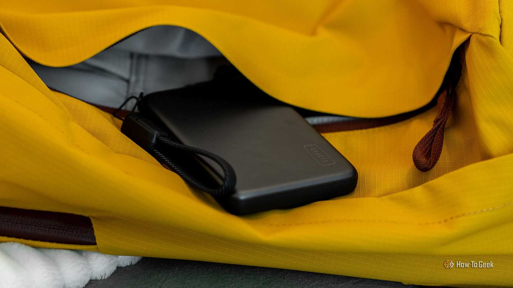 INIU SnapGo Air Power Bank in a yellow gym bag pocket