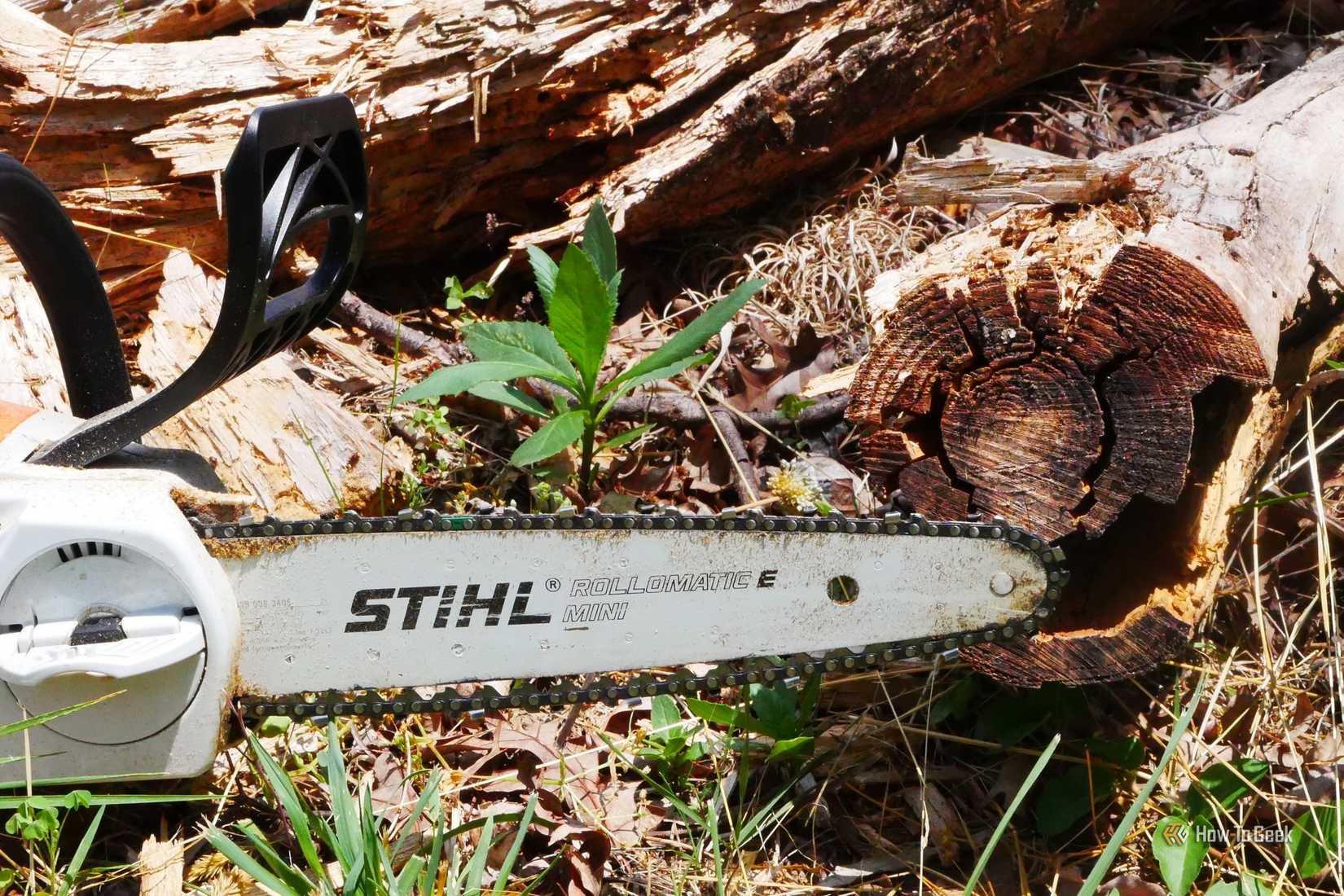Stihl chainsaw with a chopped log in the background.