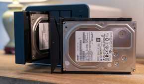 TerraMaster F4-425 Pro NAS drive tray with HGST 3.5-inch hard drive outside bay.