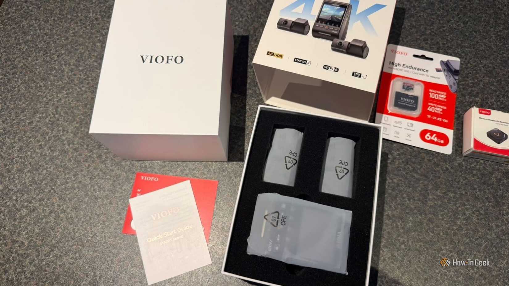 VIOFO A329S 3CH full kit laid out showing the open retail box, foam-packed main unit, accessories, 64GB microSD card, and wireless Bluetooth remote