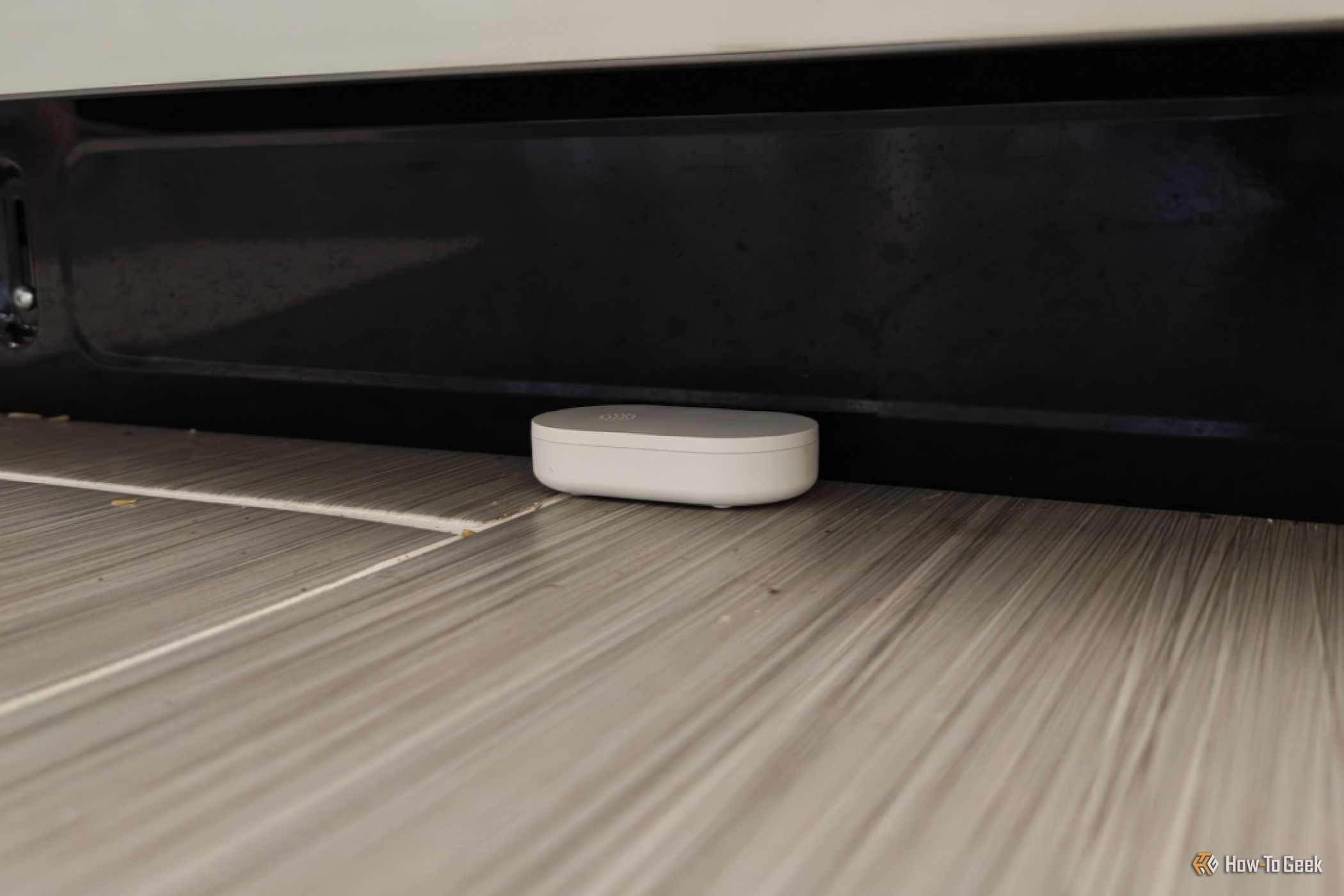 An IKEA KLIPPBOK water sensor underneath a dishwasher.