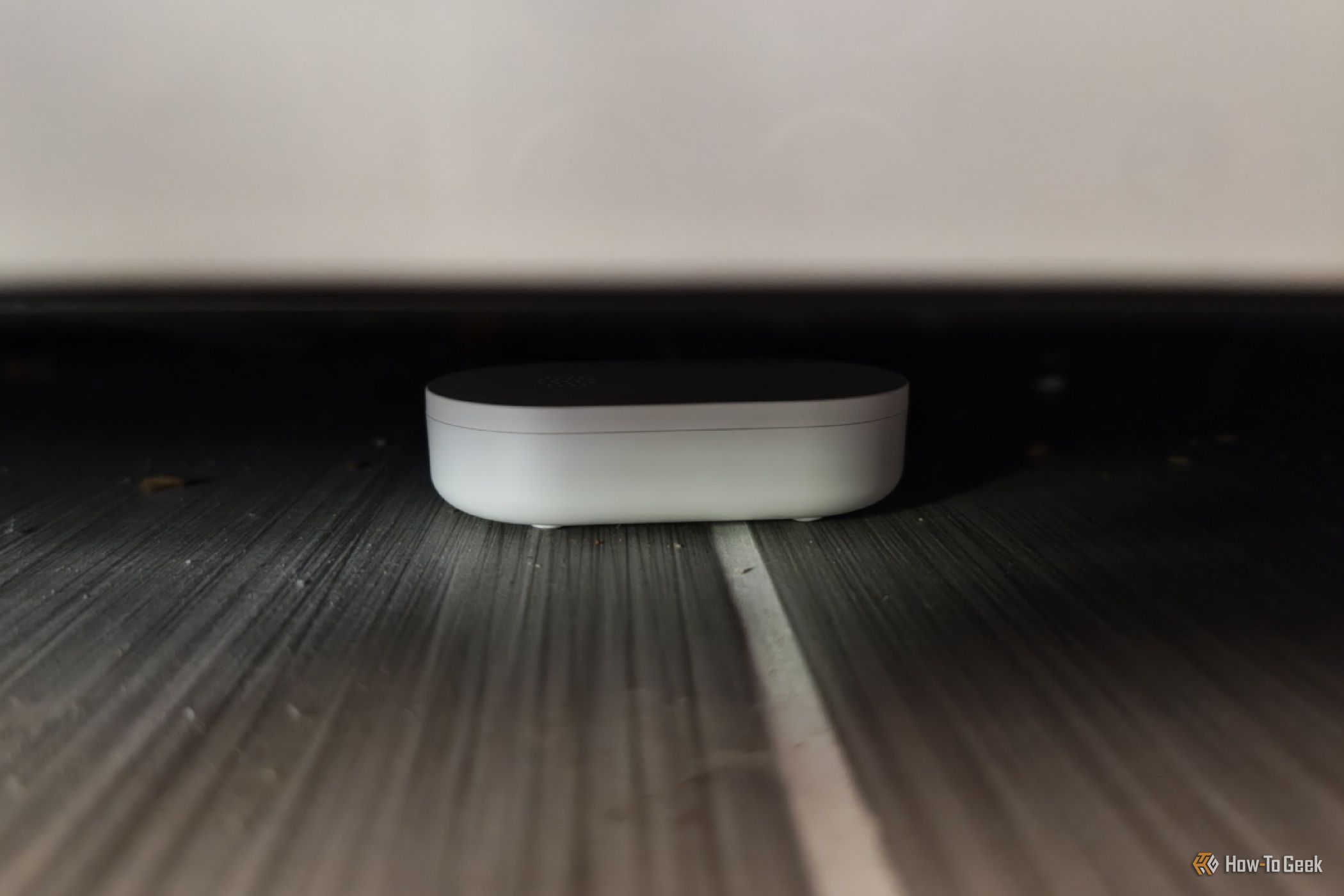 An IKEA KLIPPBOK water sensor underneath a refrigerator.