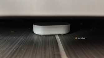 An IKEA KLIPPBOK water sensor underneath a refrigerator.