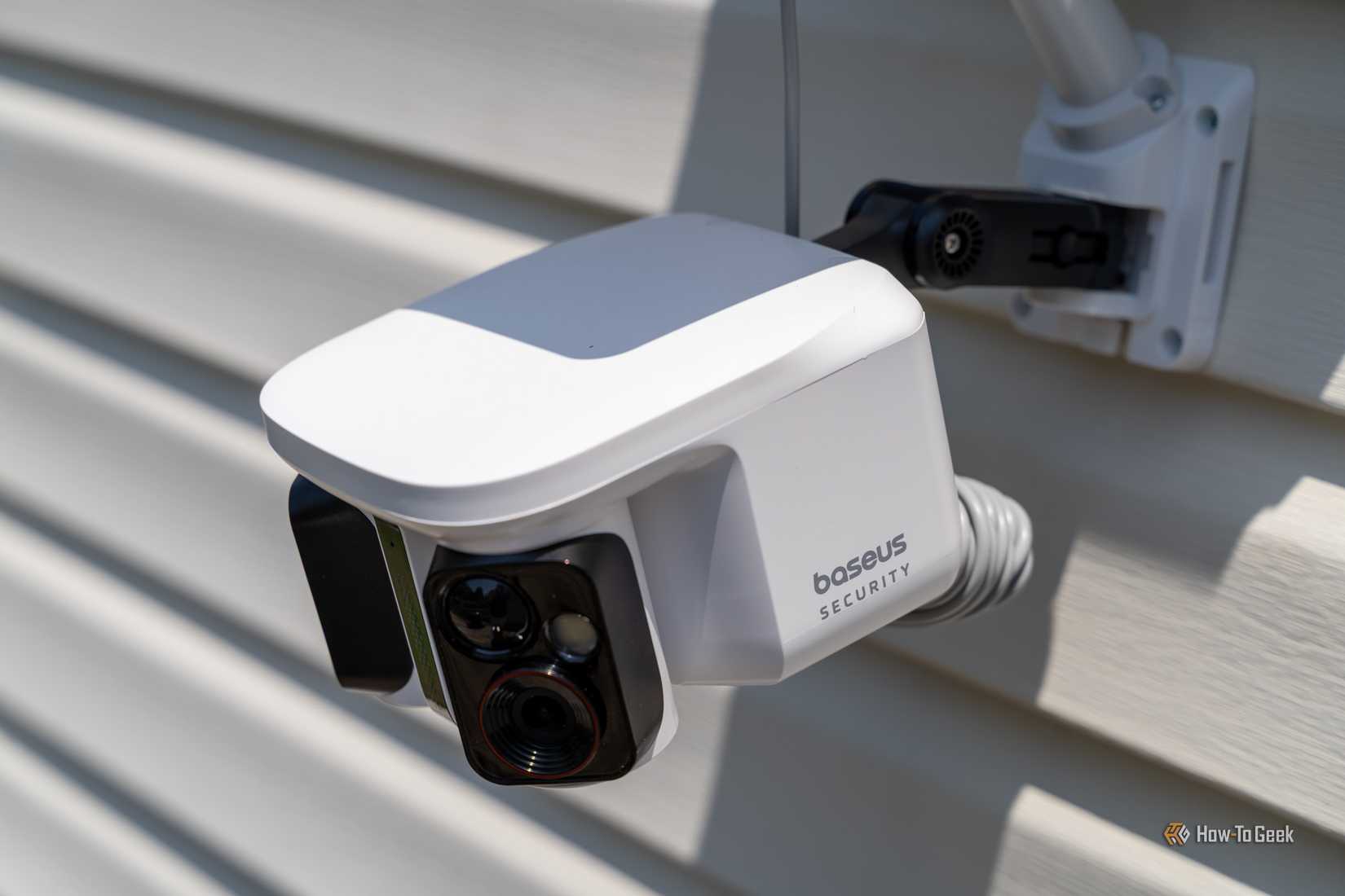 Baseus Security X1 Pro angled close-up showing camera body and wall mount arm.