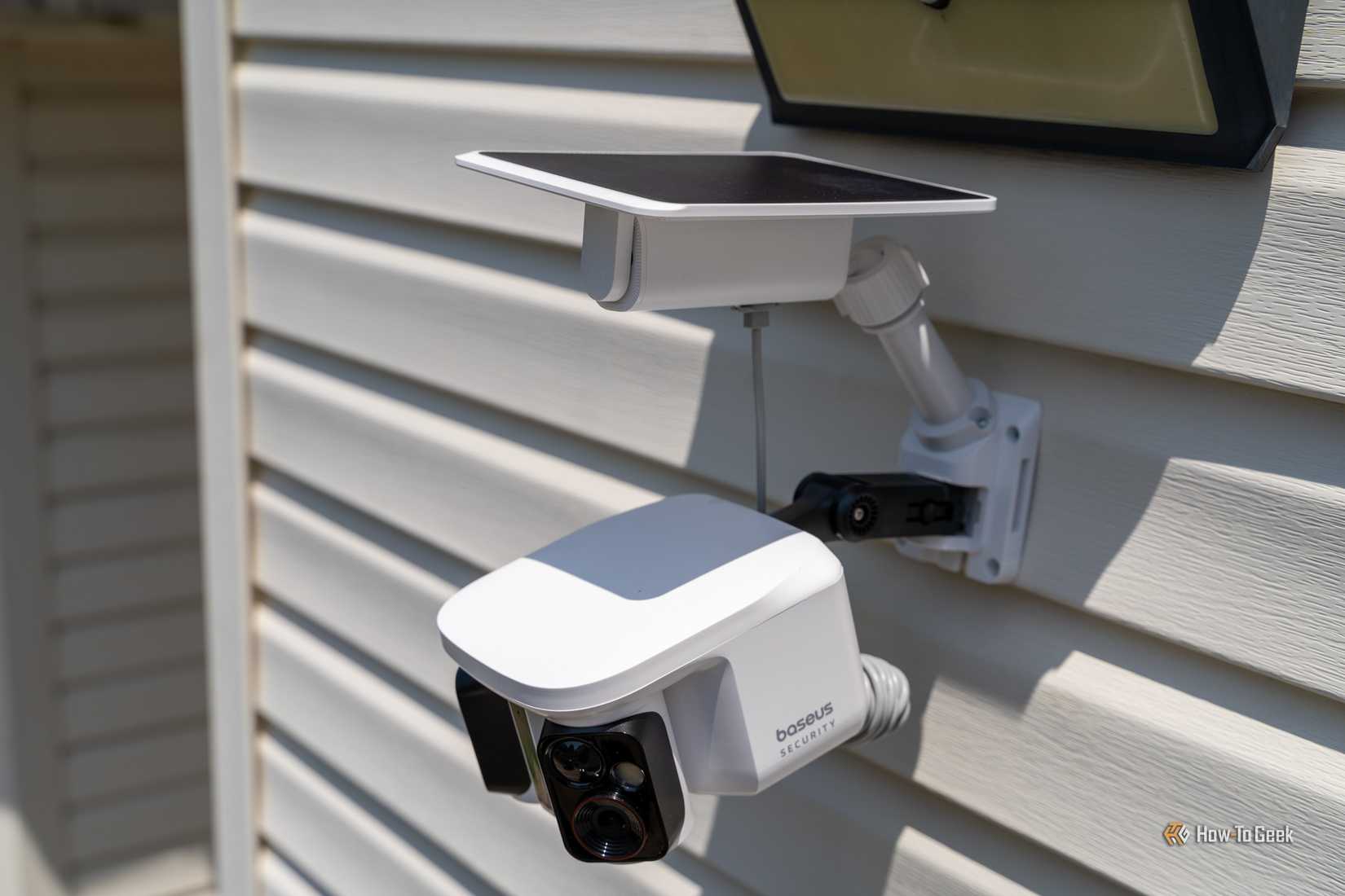 Baseus Security X1 Pro solar panel and camera mounted below outdoor light.