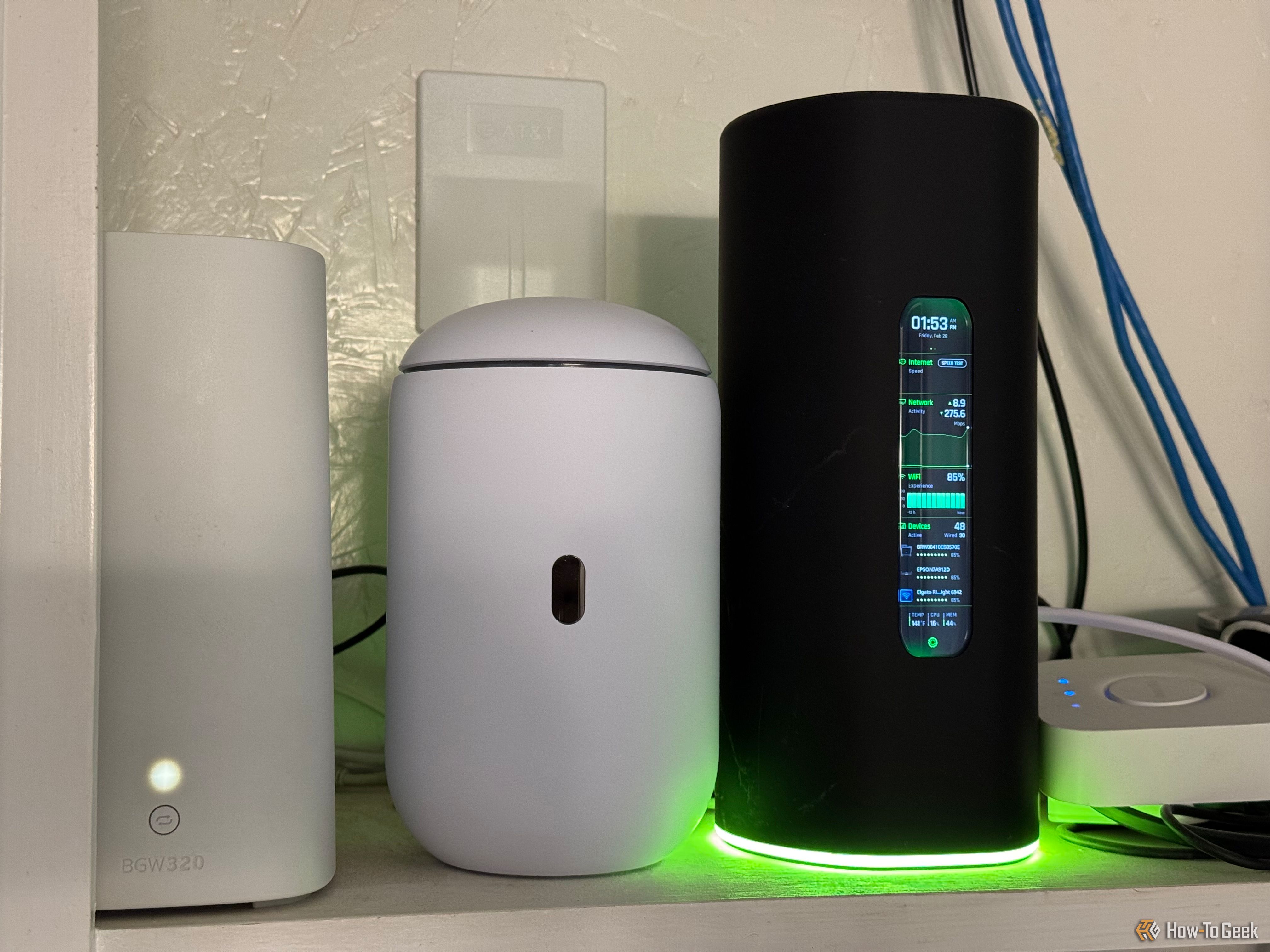 The AmpliFi Alien router next to the Dream Router 7 and AT&T Wi-Fi 6 router.