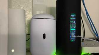 The AmpliFi Alien router next to the Dream Router 7 and AT&T Wi-Fi 6 router.