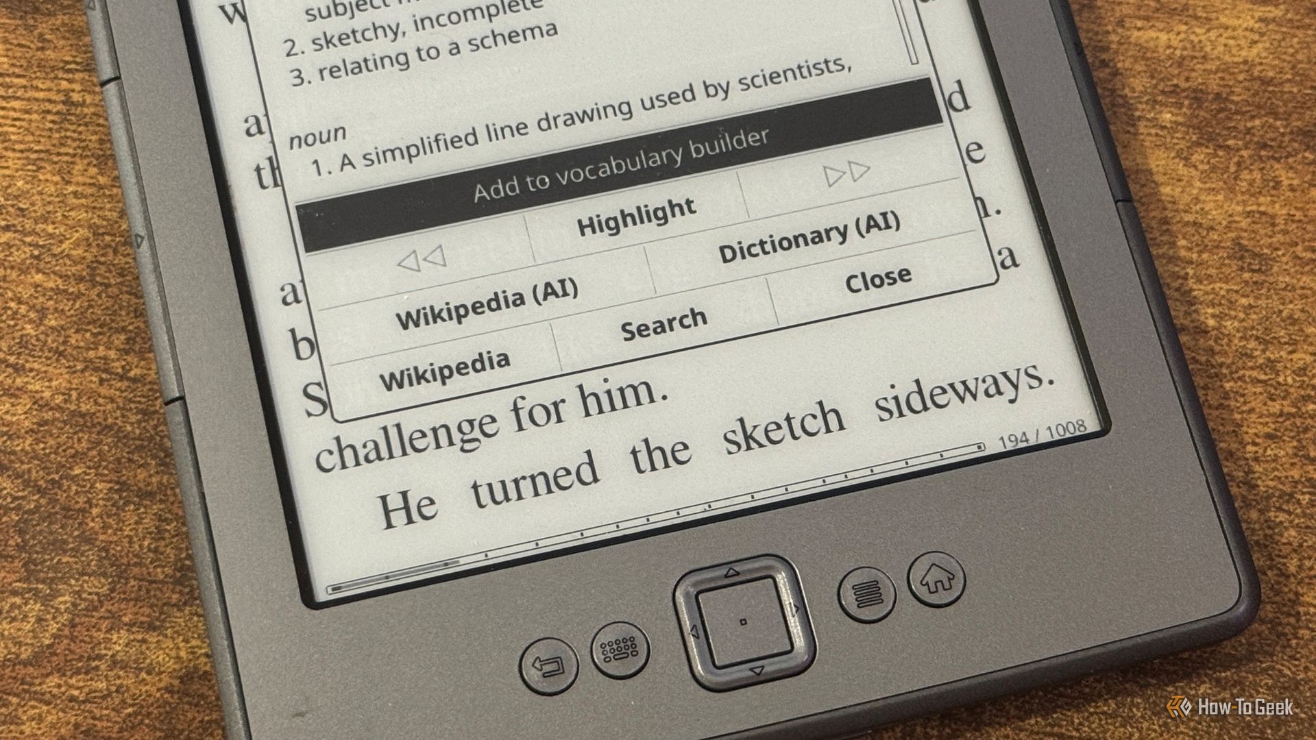 Kindle dictionary popup defining schematic with Wikipedia AI and Dictionary AI options.