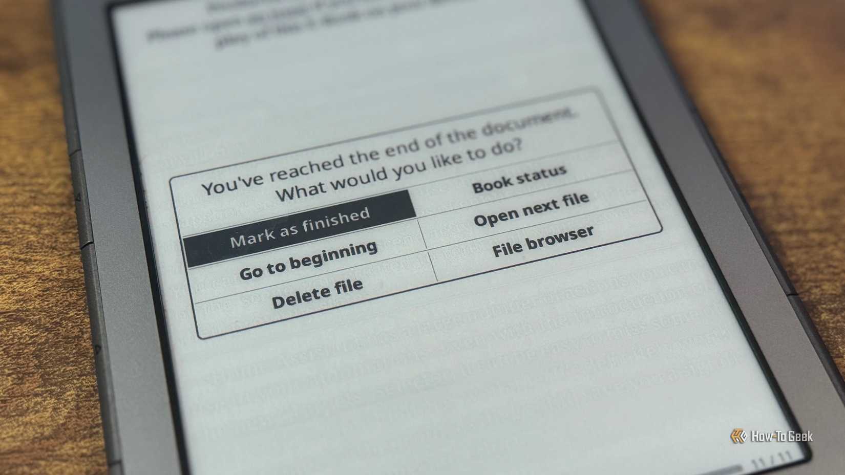 Kindle showing KOReader Youve reached the end of the document dialog with Mark as finished Go to beginning Delete file Book status Open next file and File browser options.