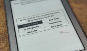 Kindle showing KOReader Youve reached the end of the document dialog with Mark as finished Go to beginning Delete file Book status Open next file and File browser options.