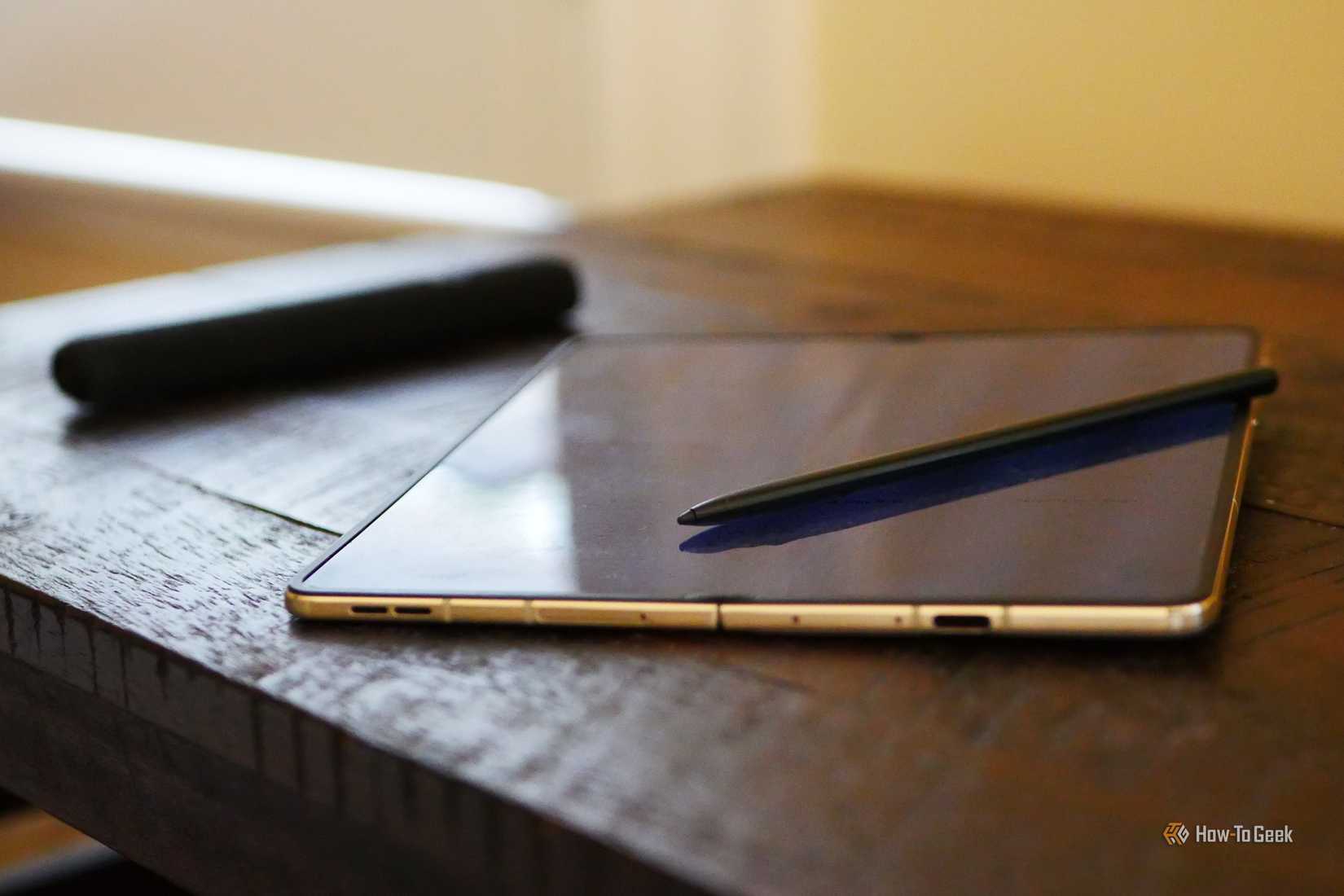 Moto Pen Ultra lying on top of a Razr Fold. 