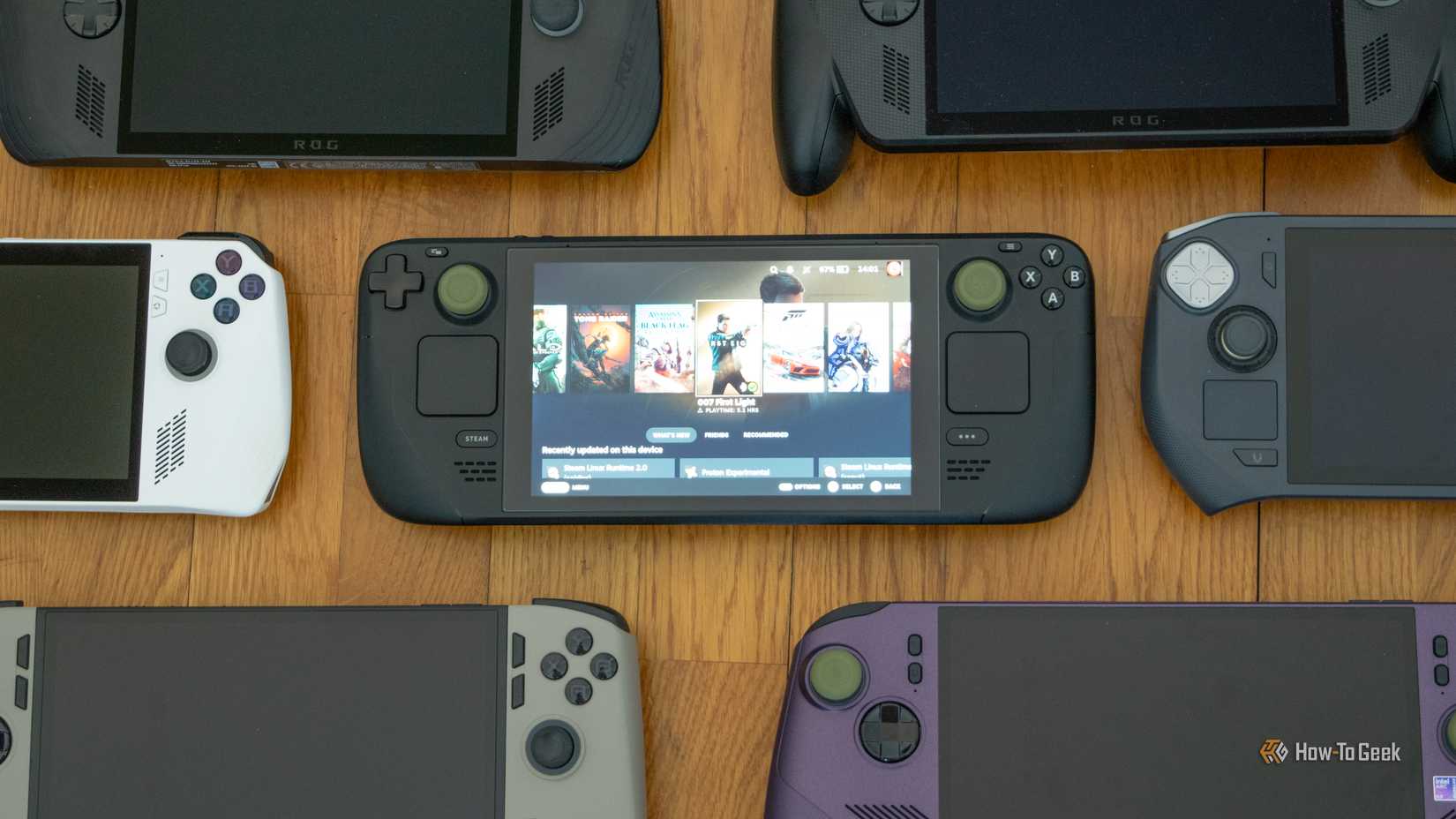 Seven Handheld PCs lying on a floor.