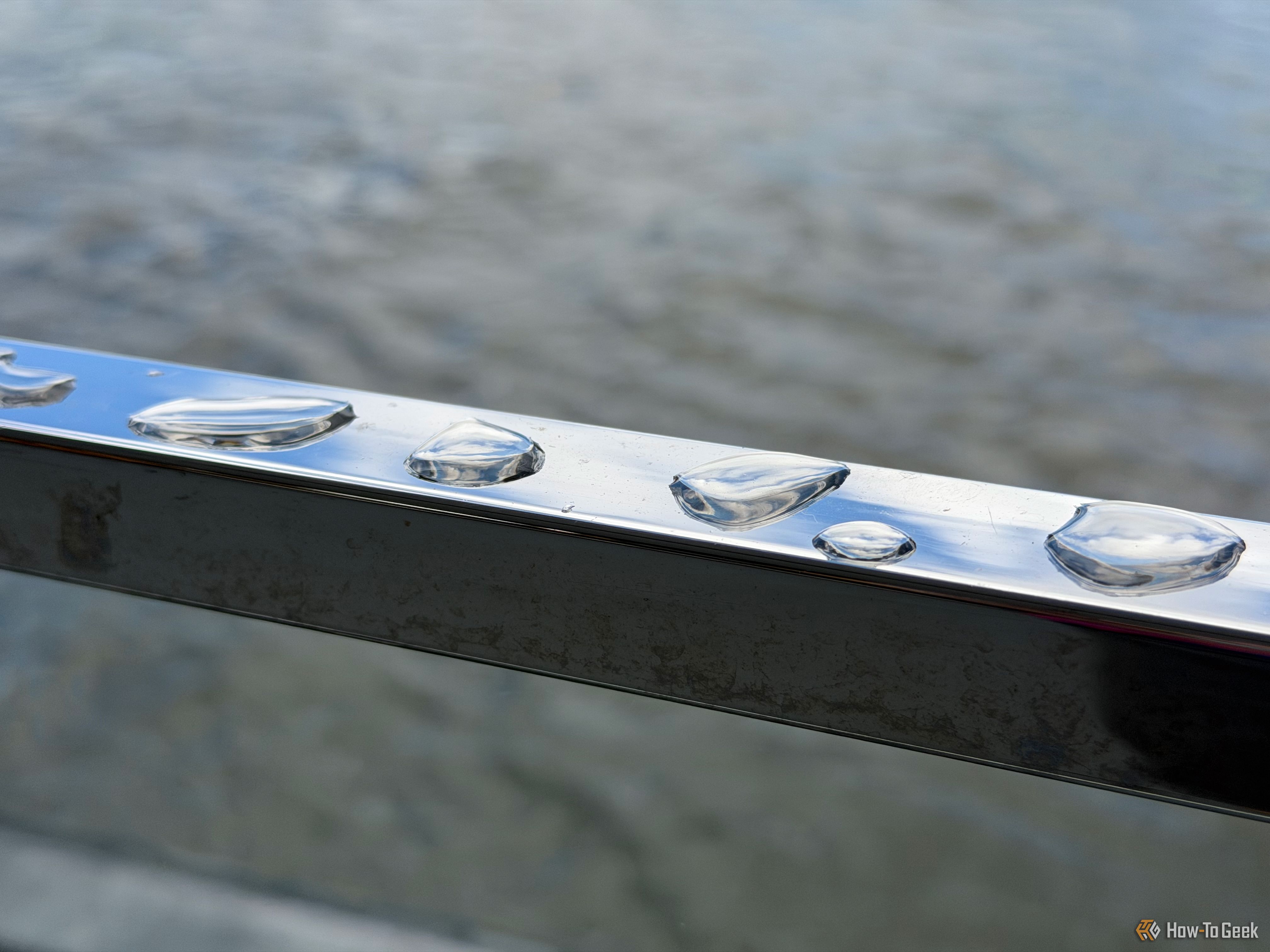 Water droplets on a railing.