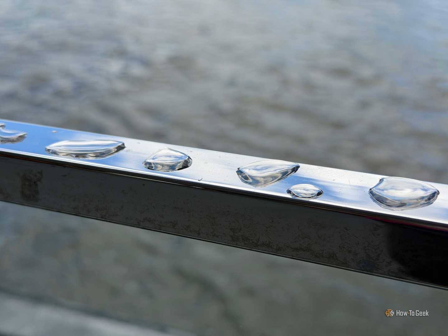 Water droplets on a railing.