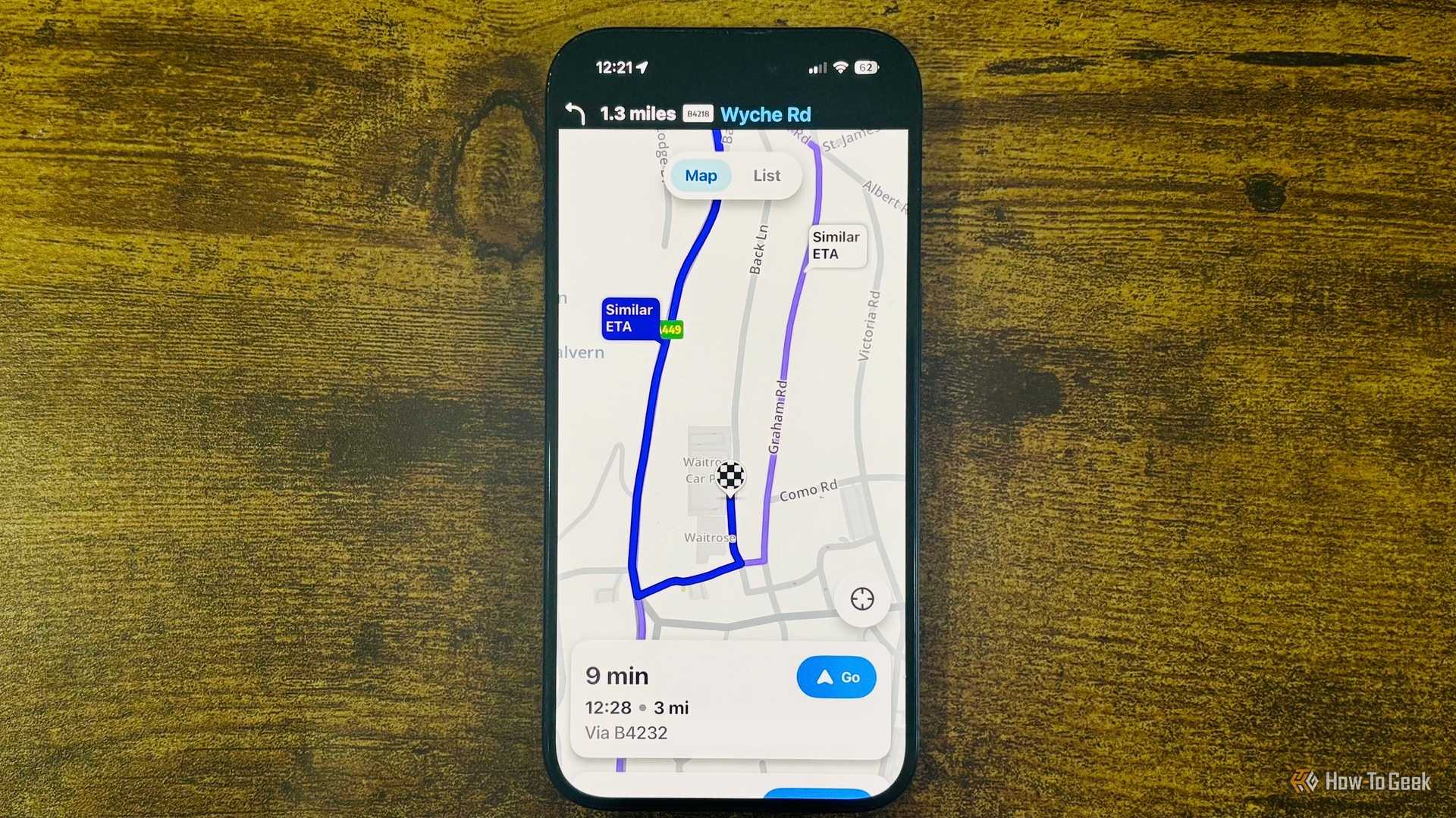Waze running on an iPhone with a close up showing a 9 minute route to Waitrose and Partners with a Similar ETA alternate route highlighted.