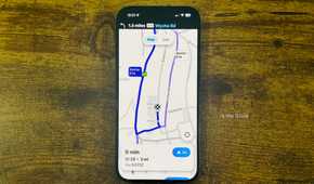 Waze running on an iPhone with a close up showing a 9 minute route to Waitrose and Partners with a Similar ETA alternate route highlighted.