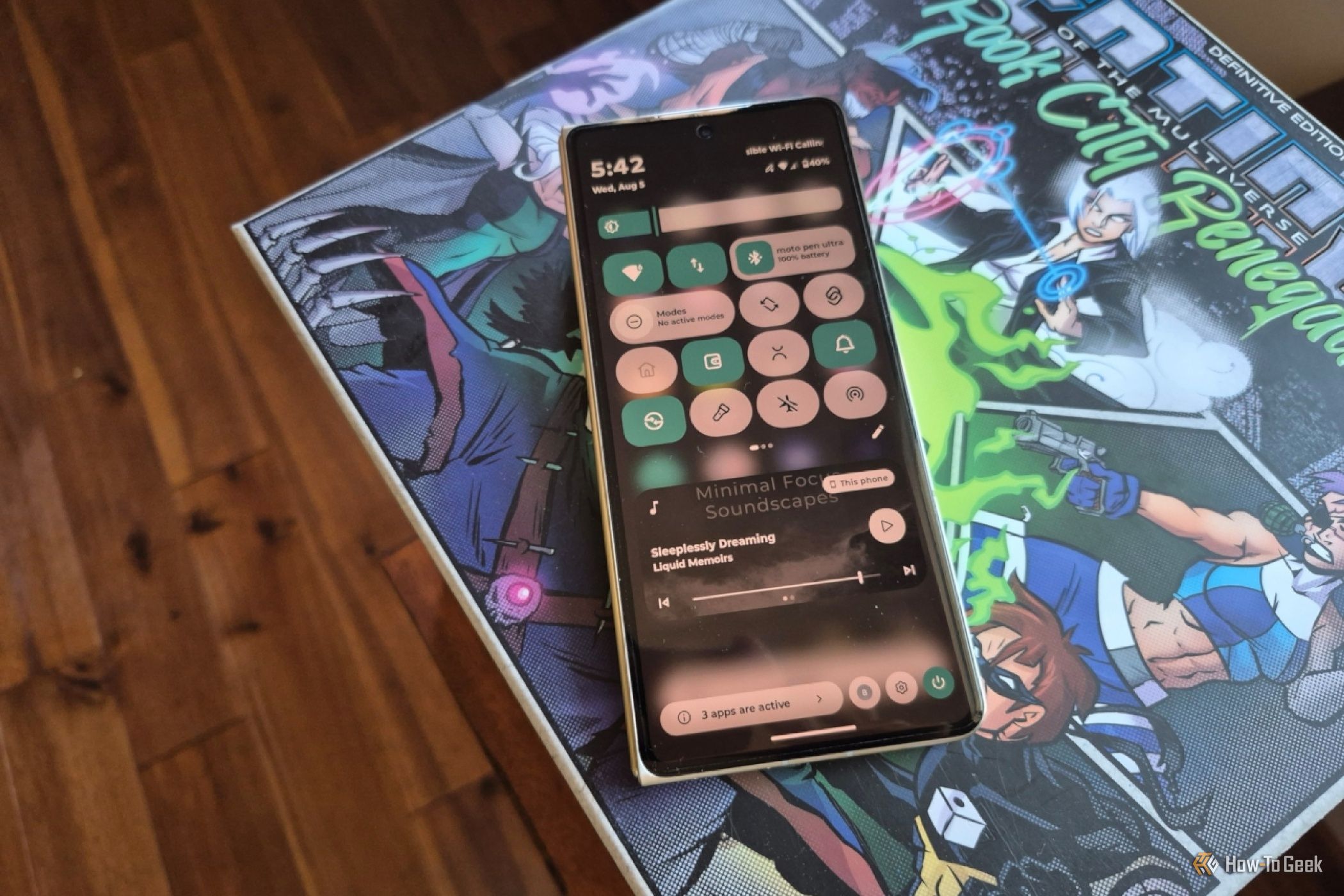 Quick status icons on a Motorola Razr Fold on top of a board game box.