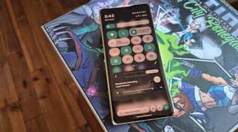 Quick status icons on a Motorola Razr Fold on top of a board game box.