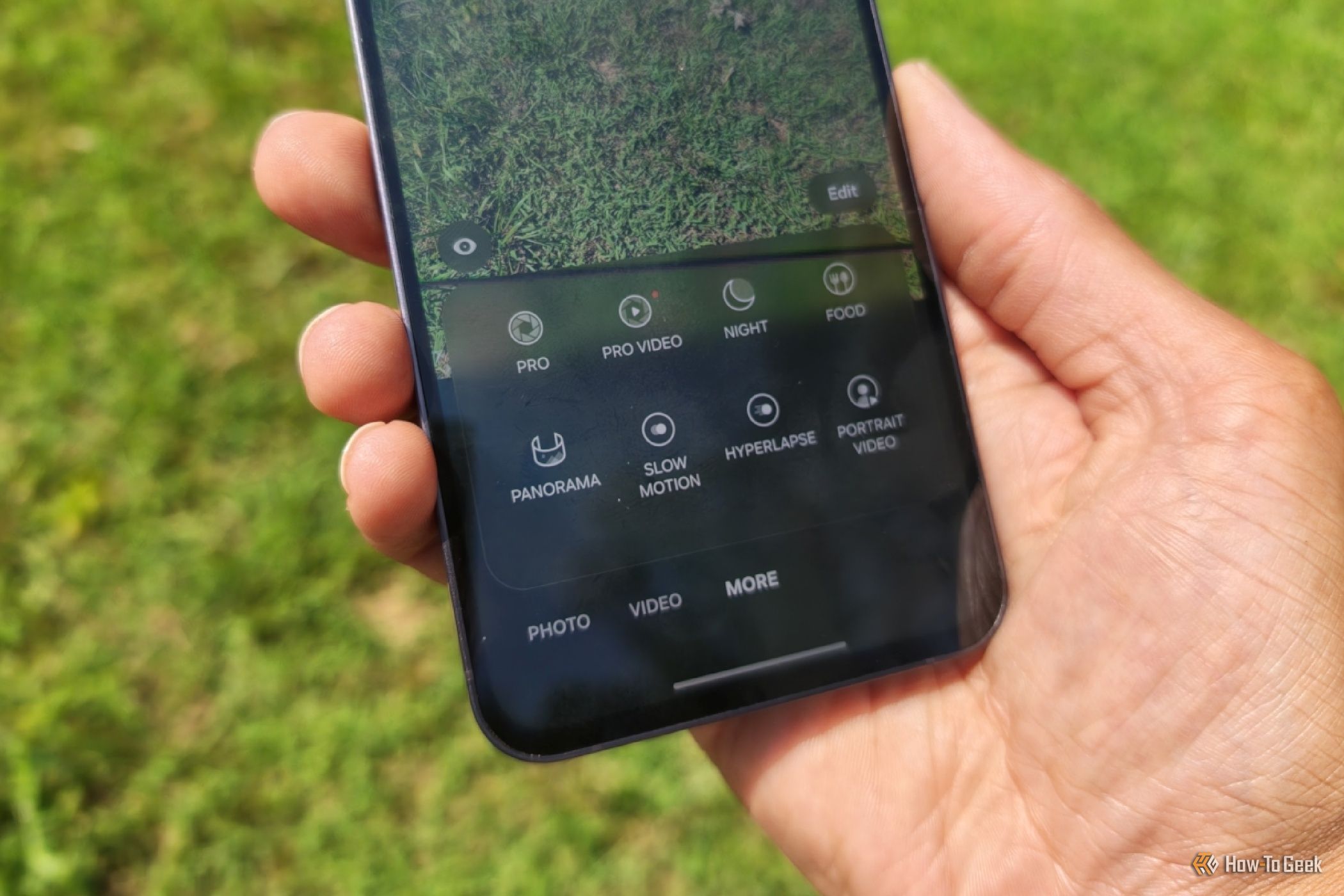 Hand holding a Samsung Galaxy S24 FE with the camera app displaying the prep mode and others..