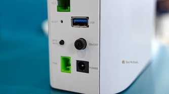 Power barrel jack and USB ports on the back of the BE7200 Dual Band WiFi 7 XGS PON VoIP Router.
