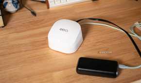 A top-down view of an Eero Wi-Fi router and power bank.