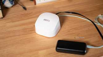 A top-down view of an Eero Wi-Fi router and power bank.