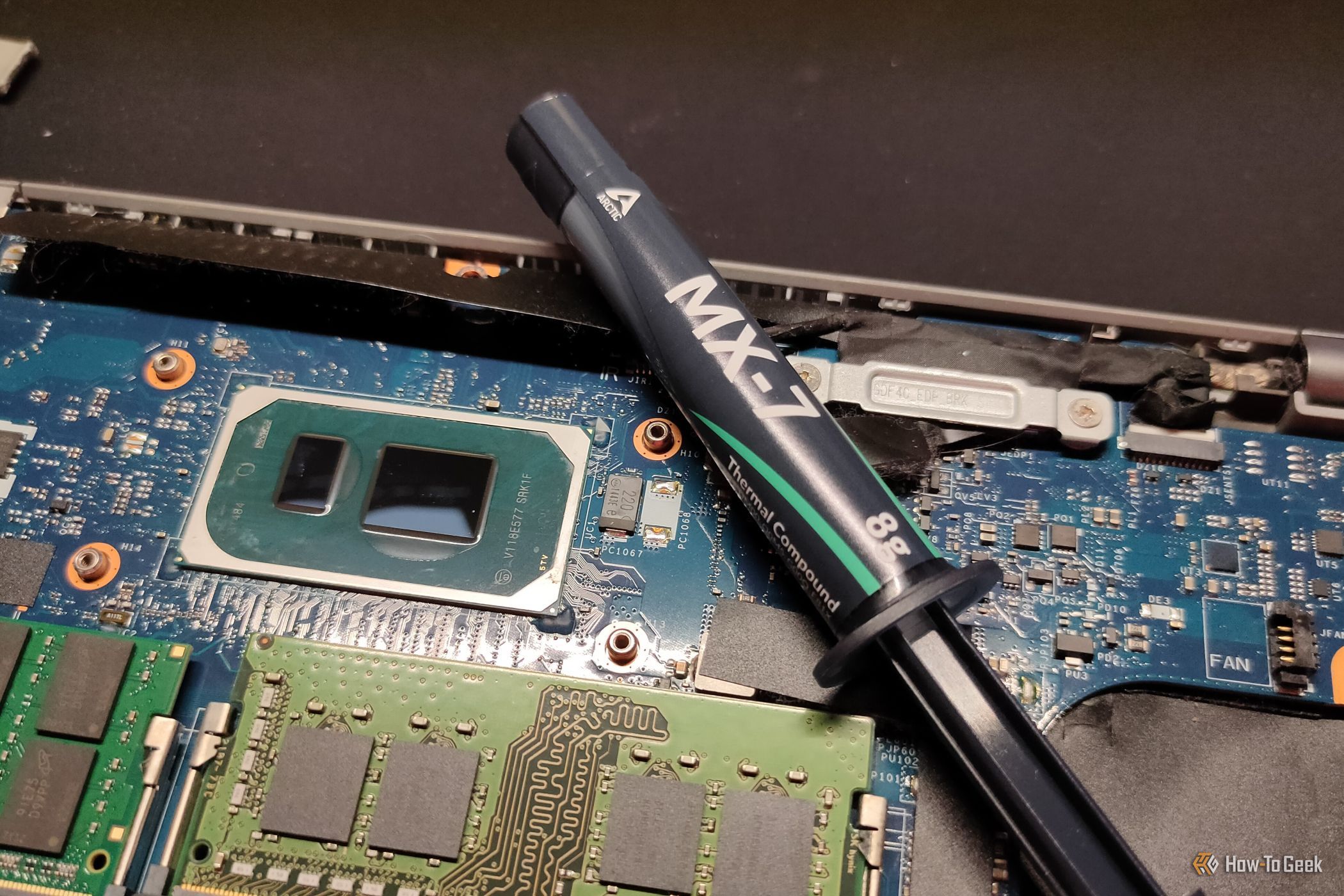 Arctic MX-7 thermal paste next to a CPU.