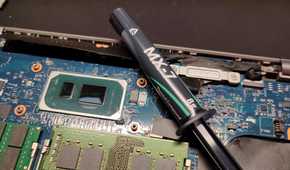 Arctic MX-7 thermal paste next to a CPU.