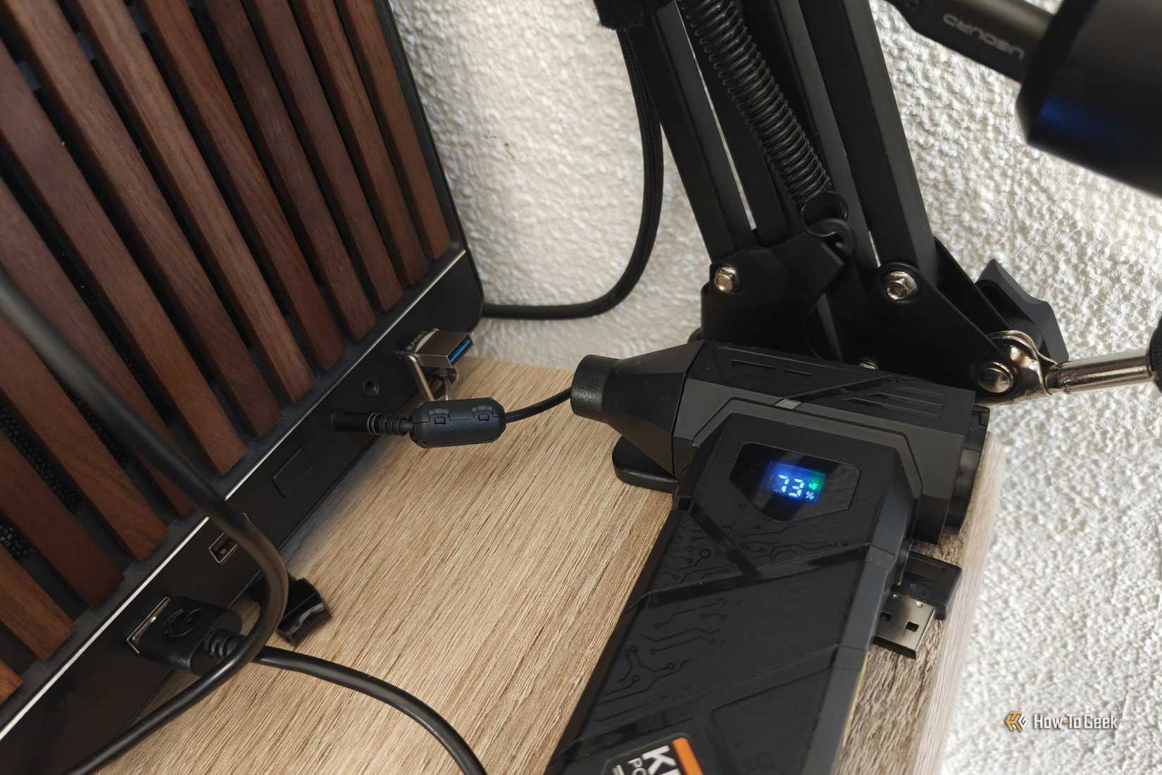 A tiny USB drive plugged into a PC being cooled by an electric duster.
