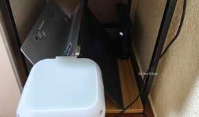 An evaporative USB cooler next to a home server.