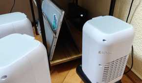 A few evaporative USB coolers next to a home server.