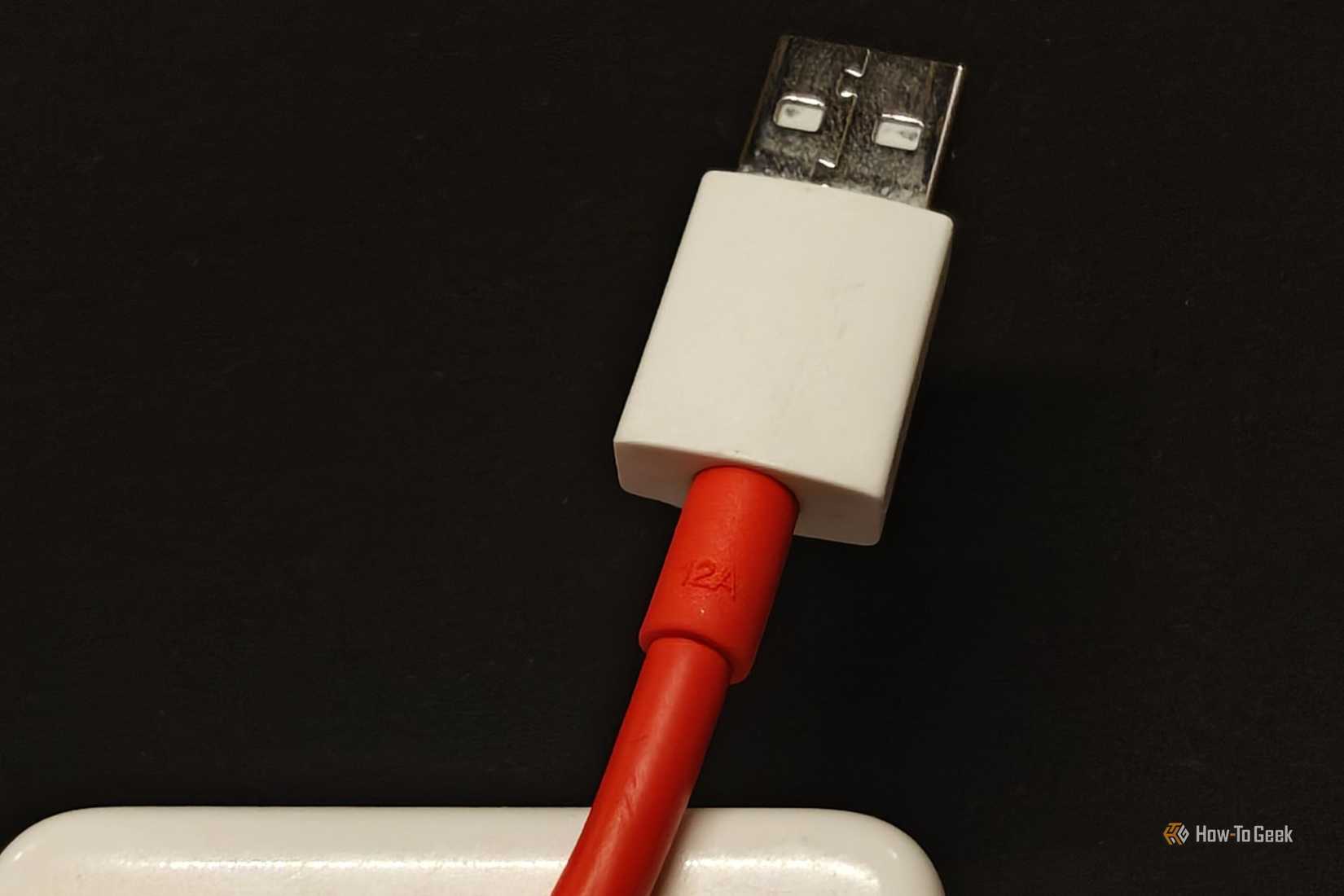 A close-up of a 12A USB-A fast-charging OnePlus cable.