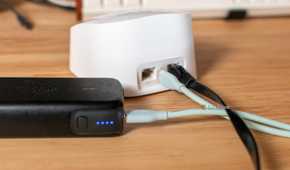 Eero router and power bank sitting on a desk.