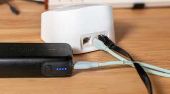 Eero router and power bank sitting on a desk.