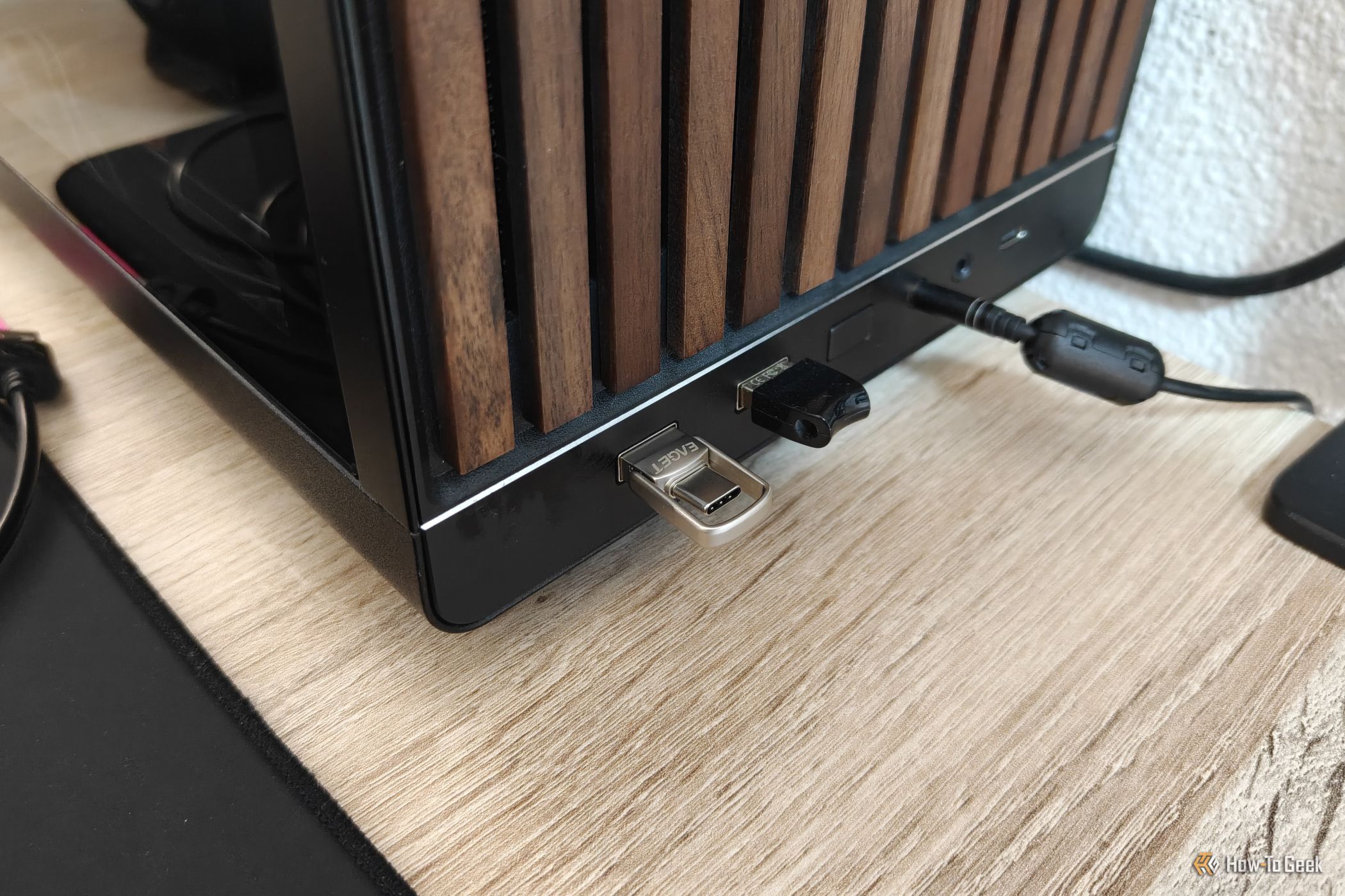 A tiny USB drive plugged into the USB-A port of a desktop computer.