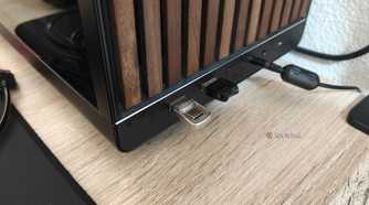 A tiny USB drive plugged into the USB-A port of a desktop computer.