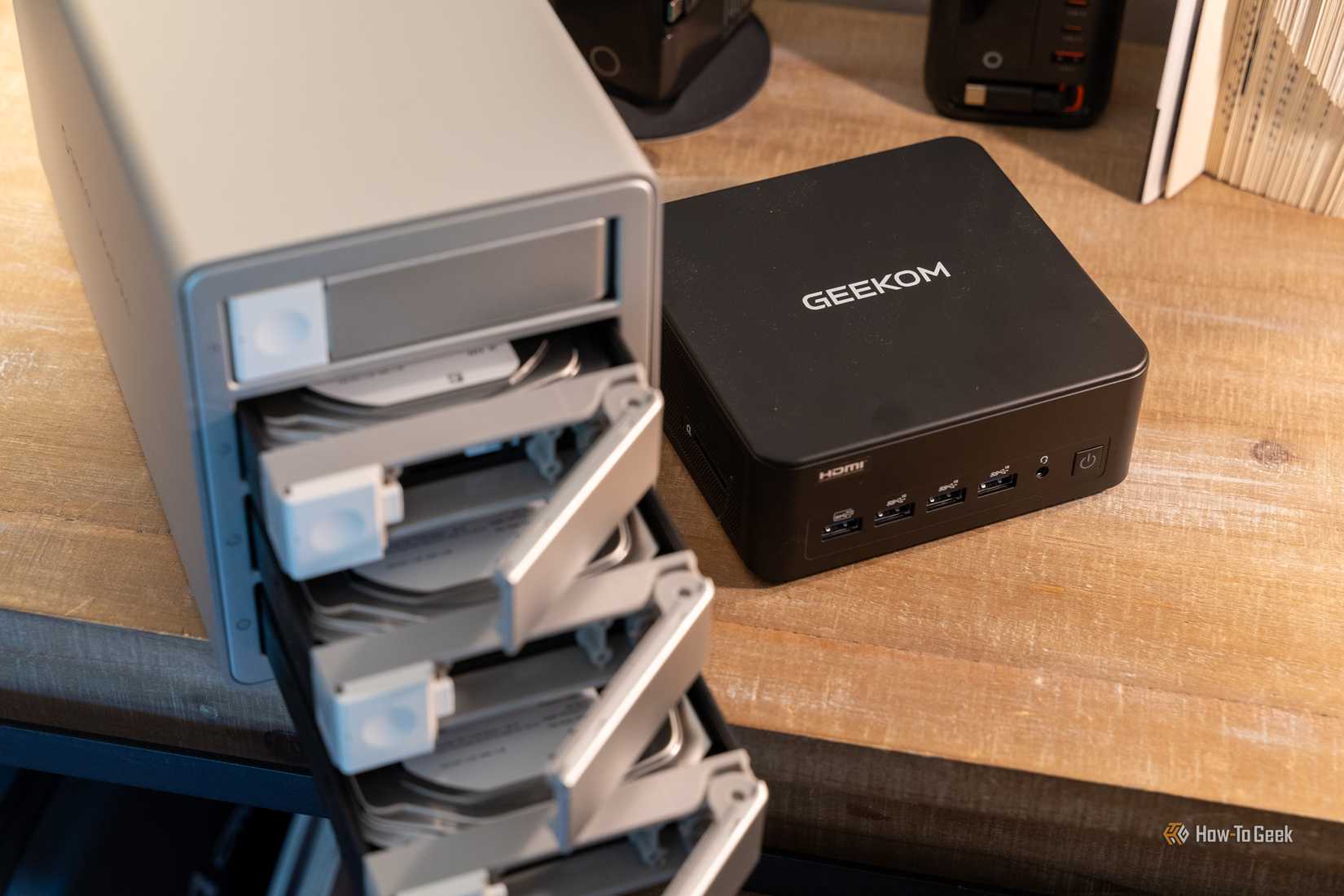 GEEKOM IT13 Max beside ORICO MacData 4-bay DAS with open drive trays.