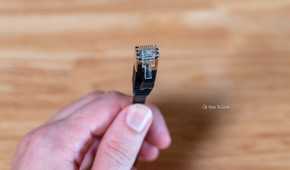 Hand holding a flat Ethernet cable.