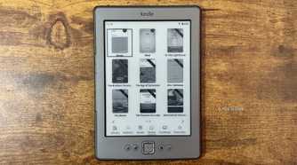 Kindle 4 running KOReader Zen UI library grid view showing book covers with the bottom navigation bar for Library Authors Series Home Continue and Favorites.