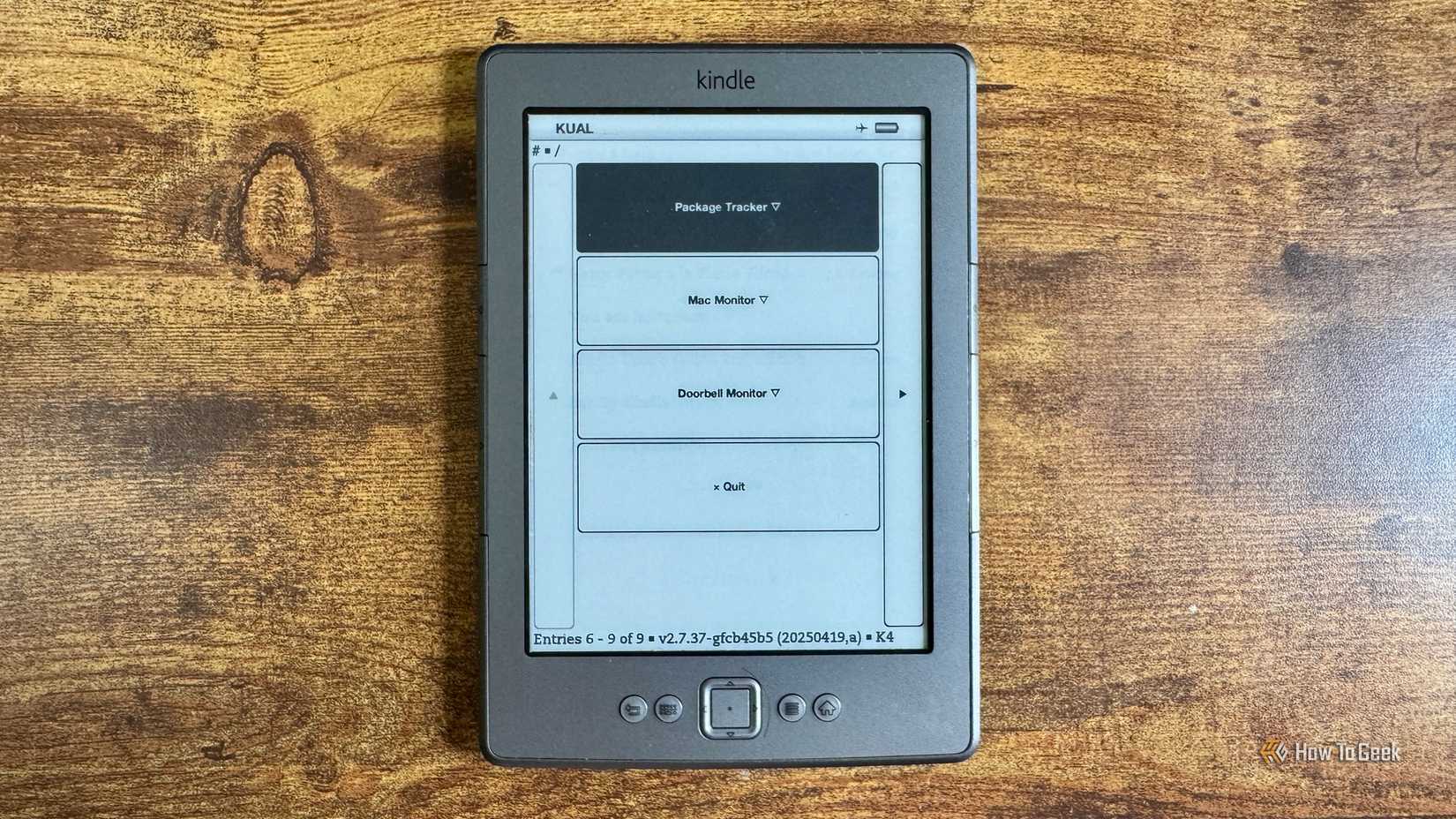 Kindle KUAL launcher menu listing Package Tracker Mac Monitor Doorbell Monitor and Quit options.