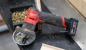 Milwaukee M12 FUEL Orbital Detail Sander overhead side view on workshop bench.