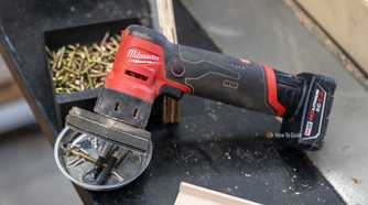 Milwaukee M12 FUEL Orbital Detail Sander overhead side view on workshop bench.