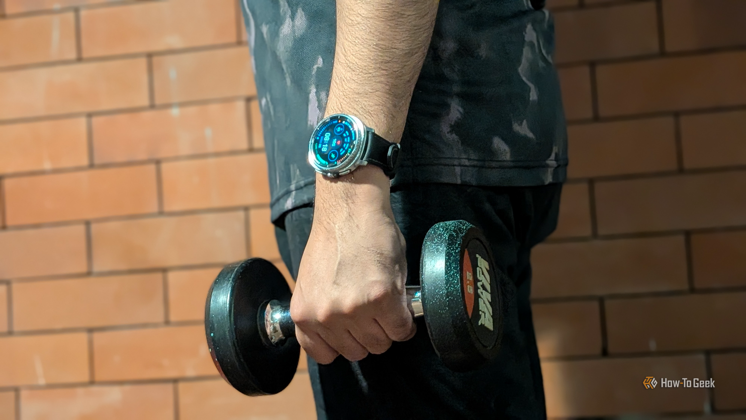 My hand holding a dumb bell in the gym with a dense health data watchface on my Galaxy Watch 8 Classic.